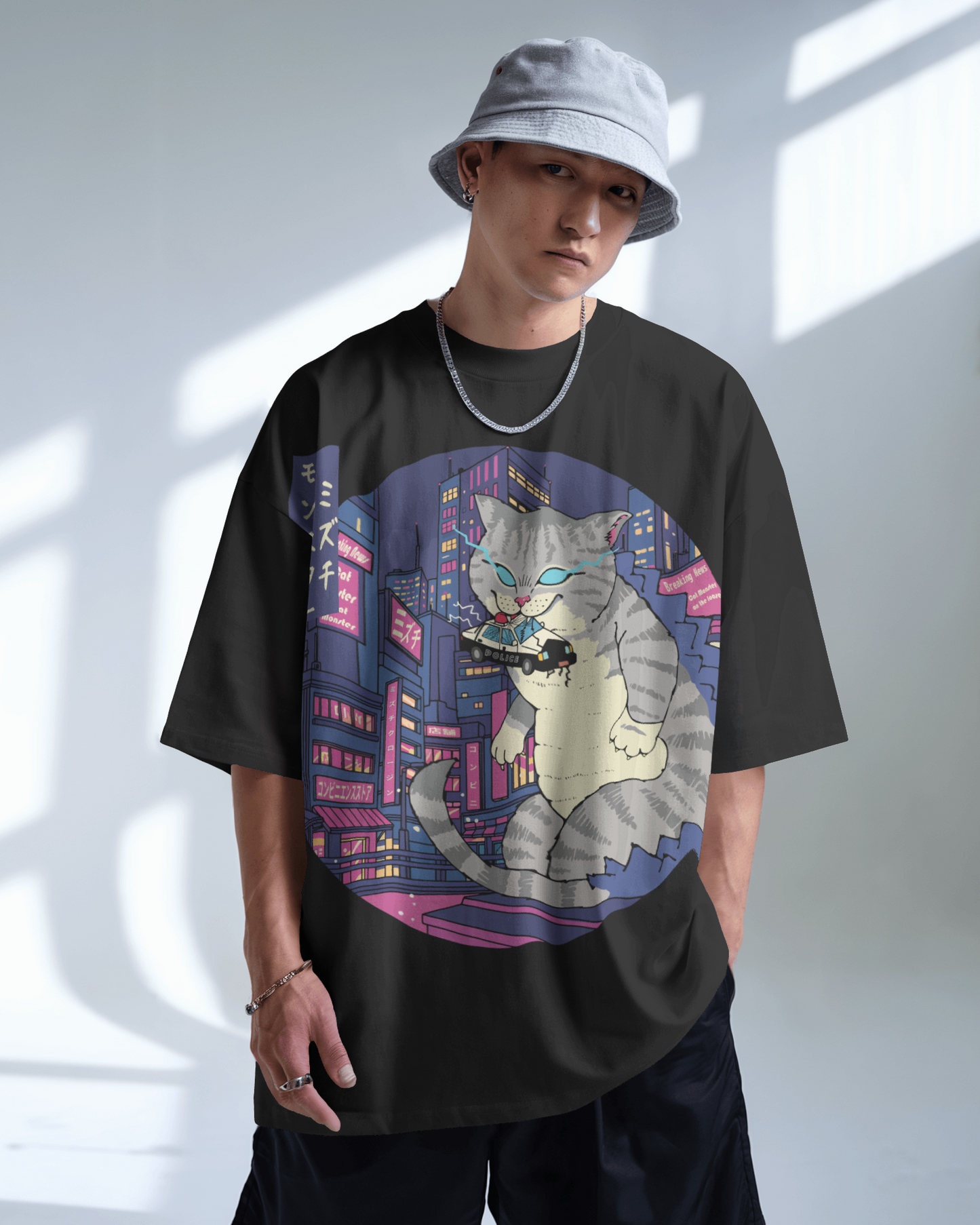 Detail Mizuchi Godzilla Cat print: Glowing eyes gray cat kaiju in pink neon cyberpunk cityscape on black tee