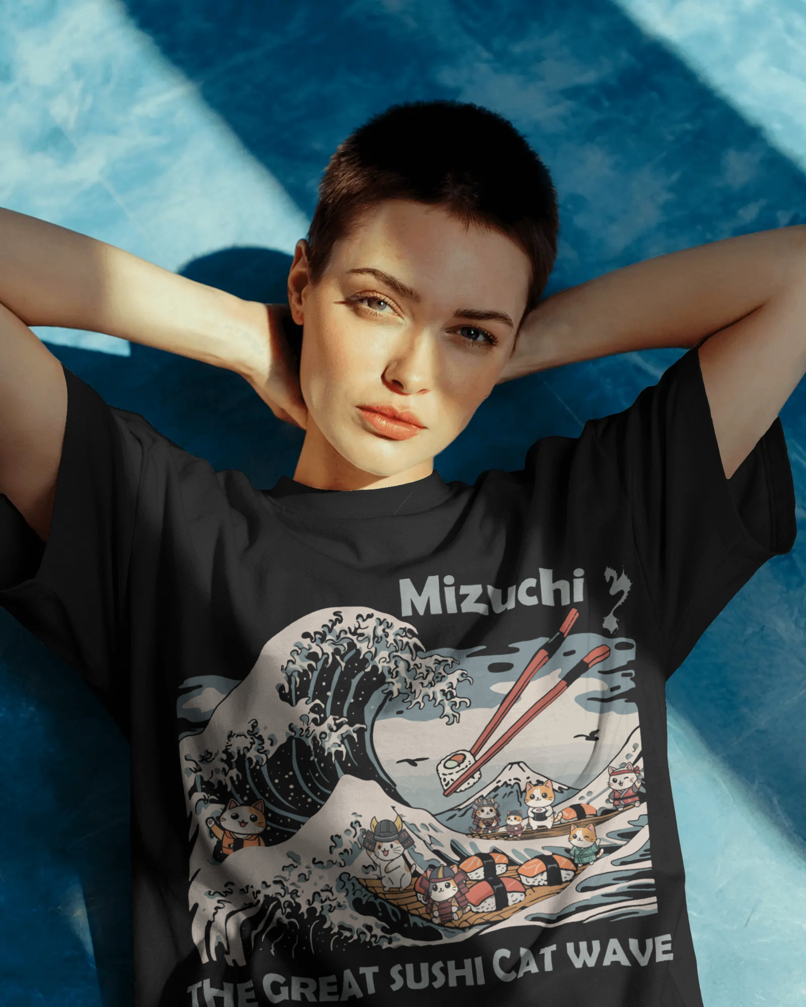 Mizuchi Great Sushi Cat Wave Tee front: Cats riding massive sushi wave with chopsticks on premium black 100% cotton t-shirt, Monochrome Series.
