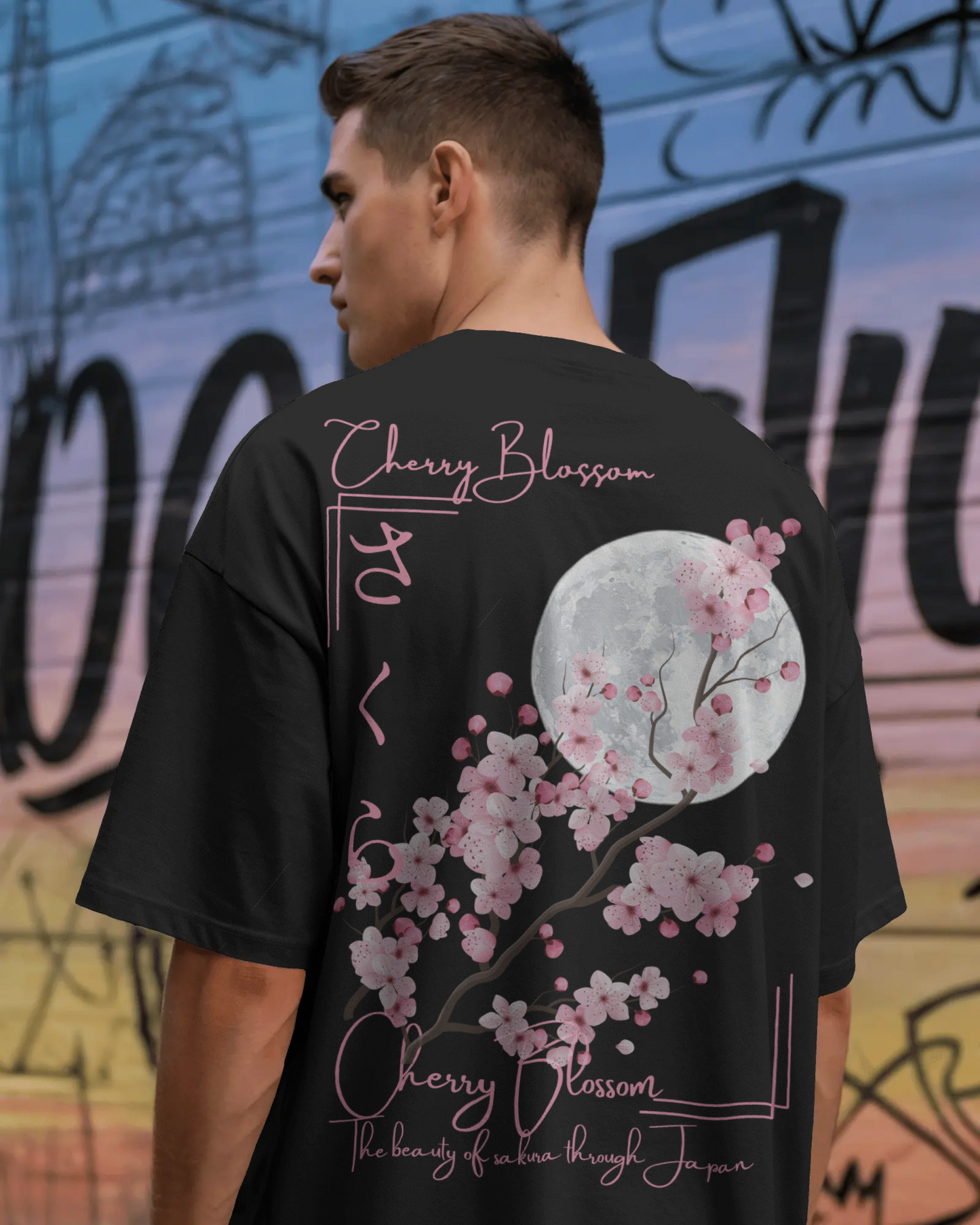 Close-up Mizuchi Sakura print: Pink cherry blossoms, moon, and Japanese text on black tee direct film print