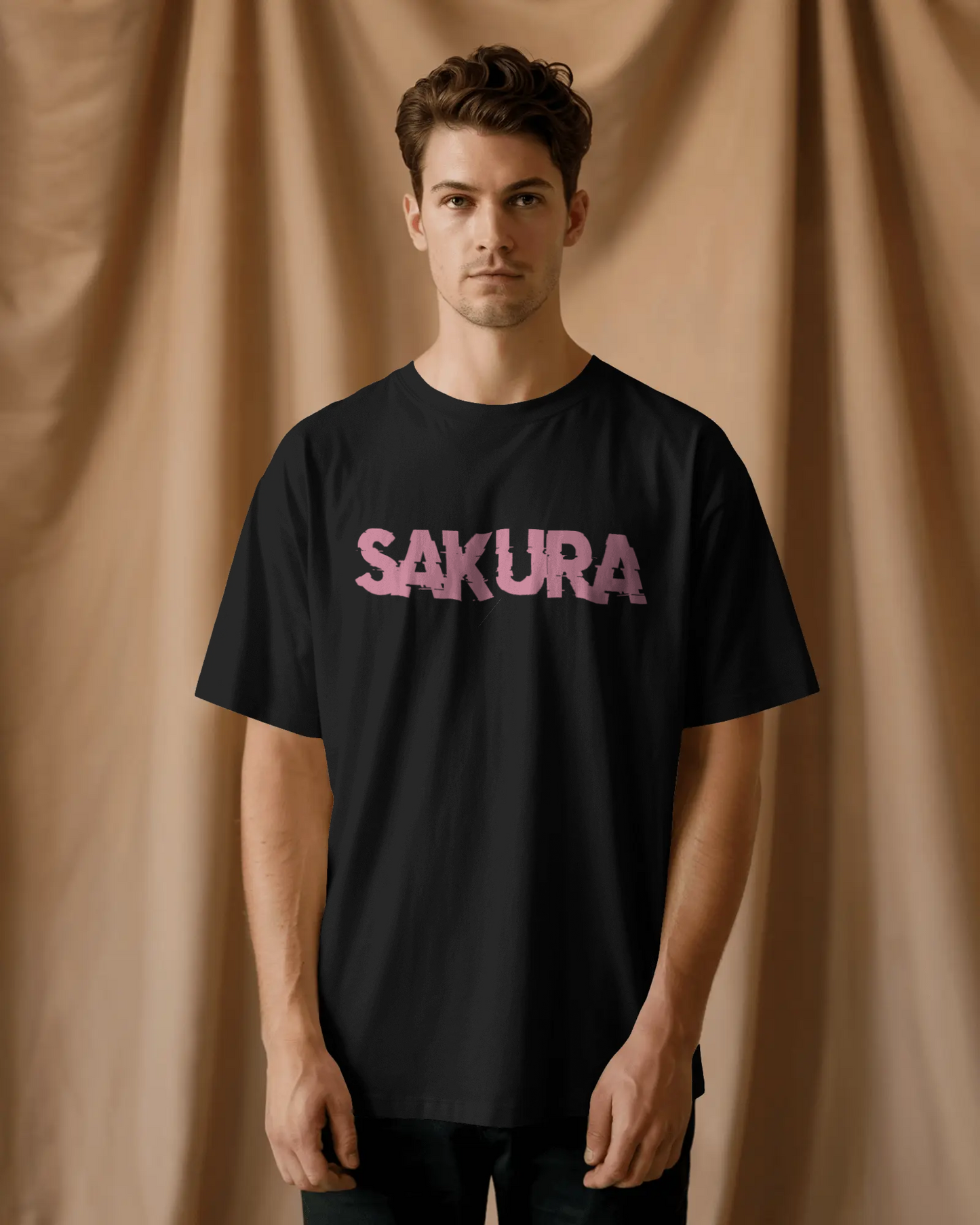 Mizuchi Sakura Tee front: Oversized pink 'SAKURA' graffiti text on premium black 100% cotton t-shirt, Monochrome Series streetwear.